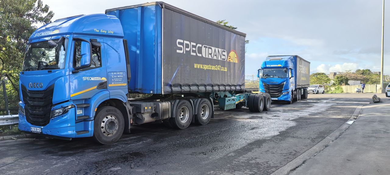 Spectrans trucks on the road between the terminal and customer sites